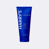Blue tube of Harry's shave cream on a light gray background